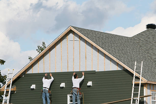 Professional Storm Damage Siding Repair technician working in Sullivan, IL